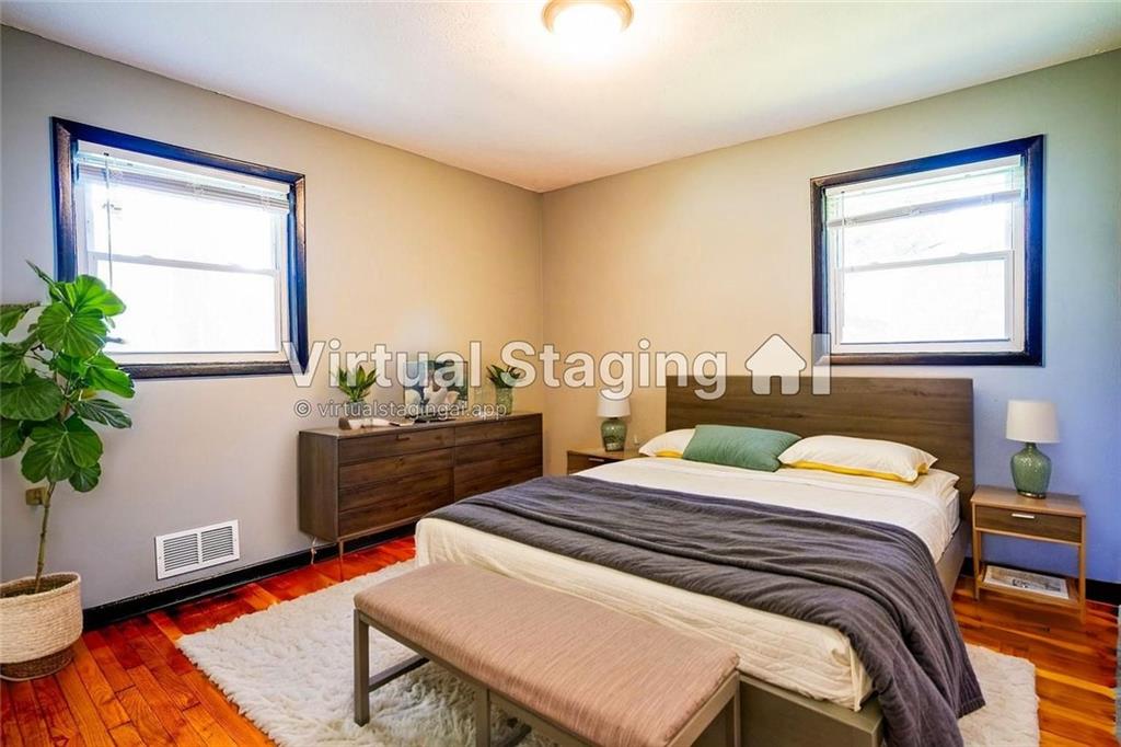 2877 Whispering Hills Drive, Unit 2875 Atlanta, GA 30341 - Photo 6 of 18 a bedroom with a bed and a potted plant