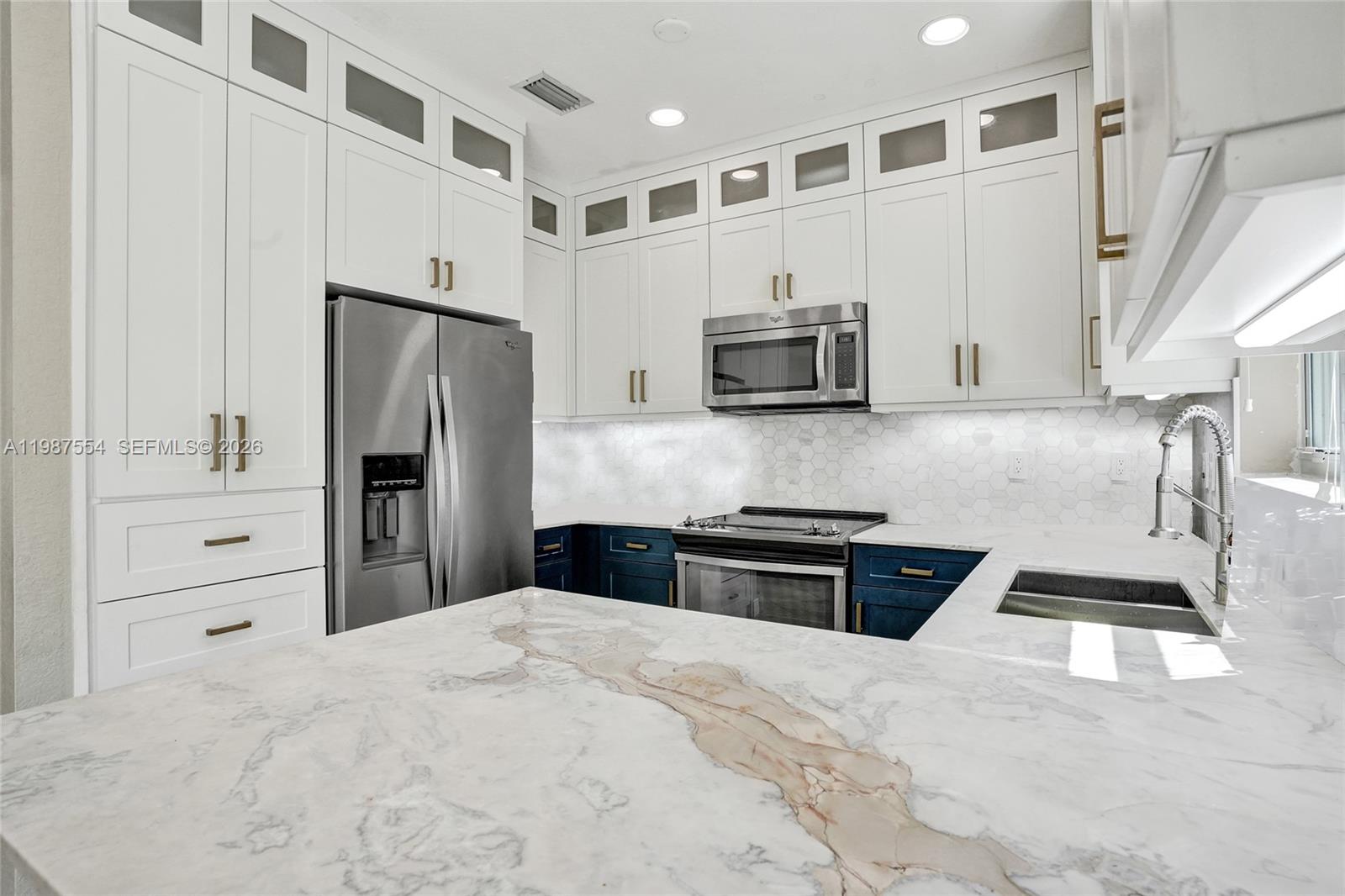 12554 Southwest 125th Terrace Miami, FL 33186 - Photo 13 of 41 a kitchen with granite countertop a refrigerator stove and sink