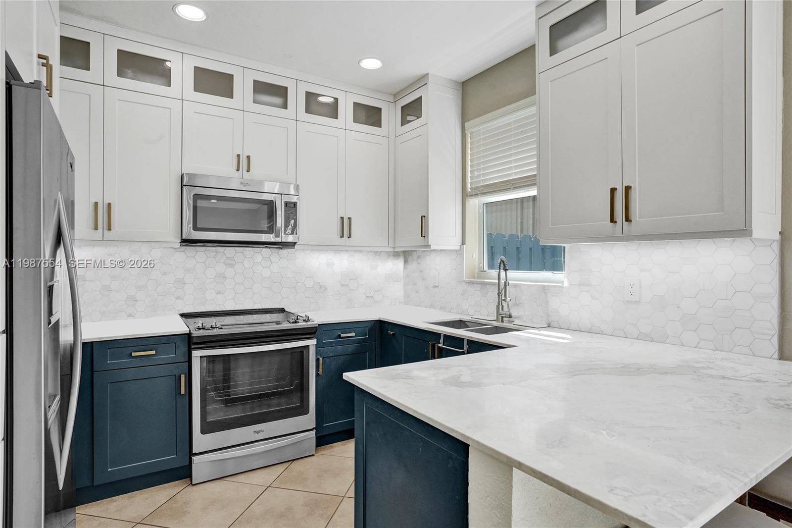 12554 Southwest 125th Terrace Miami, FL 33186 - Photo 14 of 41 a kitchen with stainless steel appliances granite countertop a sink stove and microwave