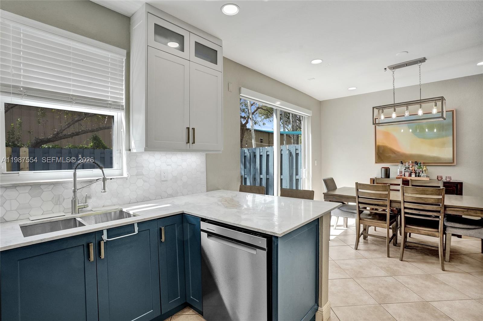 12554 Southwest 125th Terrace Miami, FL 33186 - Photo 17 of 41 a kitchen with center island table and chairs in it