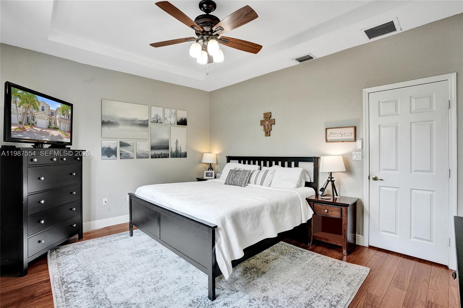 12554 Southwest 125th Terrace Miami, FL 33186 - Photo 20 of 41 a bedroom with a bed and a chandelier