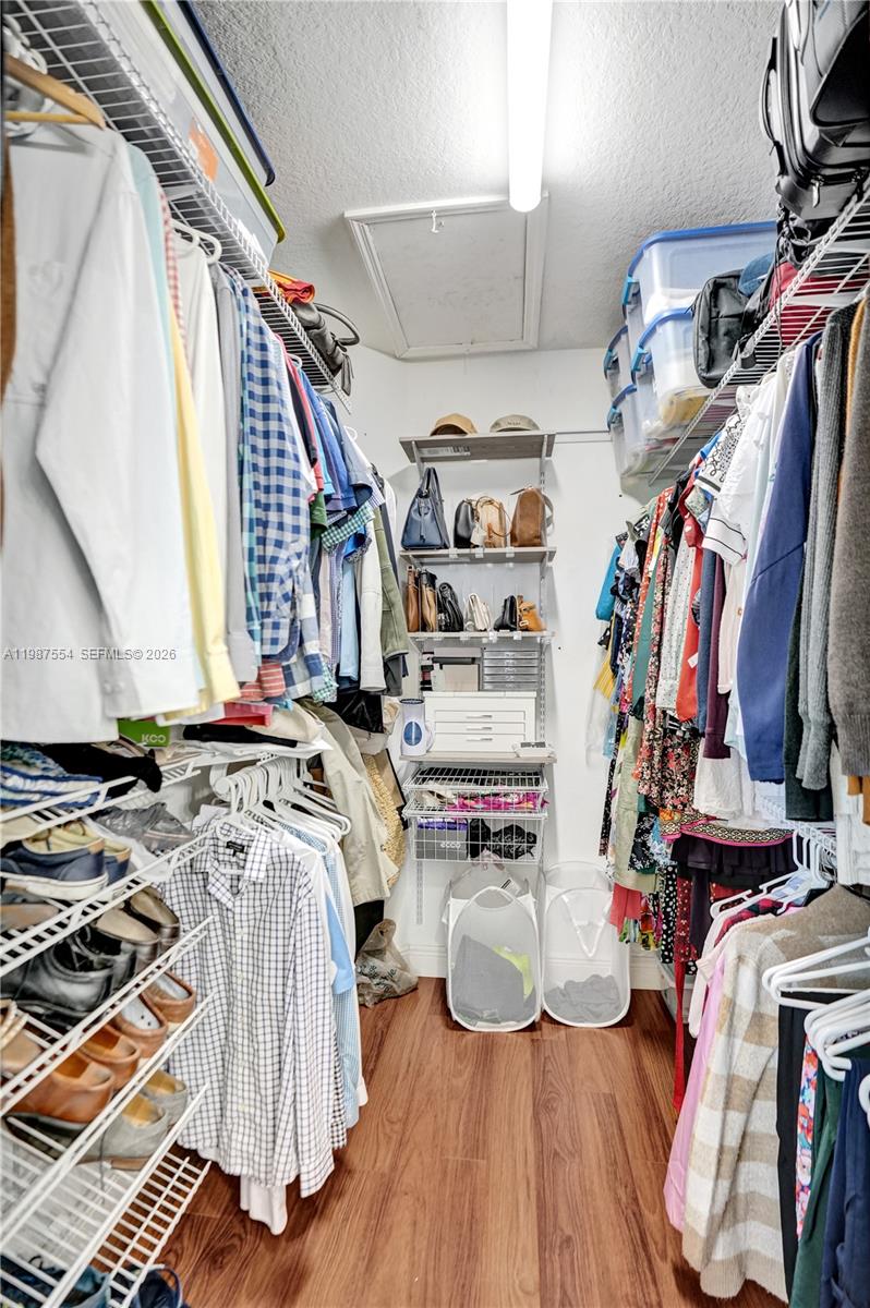 12554 Southwest 125th Terrace Miami, FL 33186 - Photo 23 of 41 a view of walk in closet with clothes and shoes