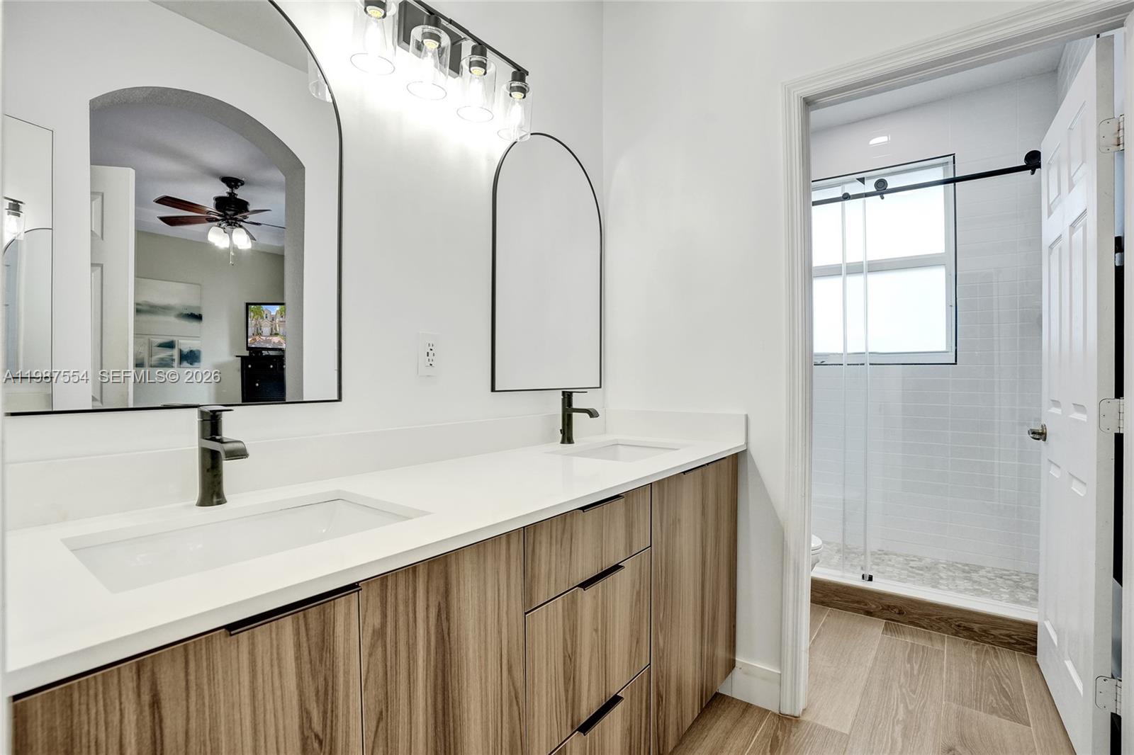 12554 Southwest 125th Terrace Miami, FL 33186 - Photo 24 of 41 a bathroom with a double vanity sink and a mirror