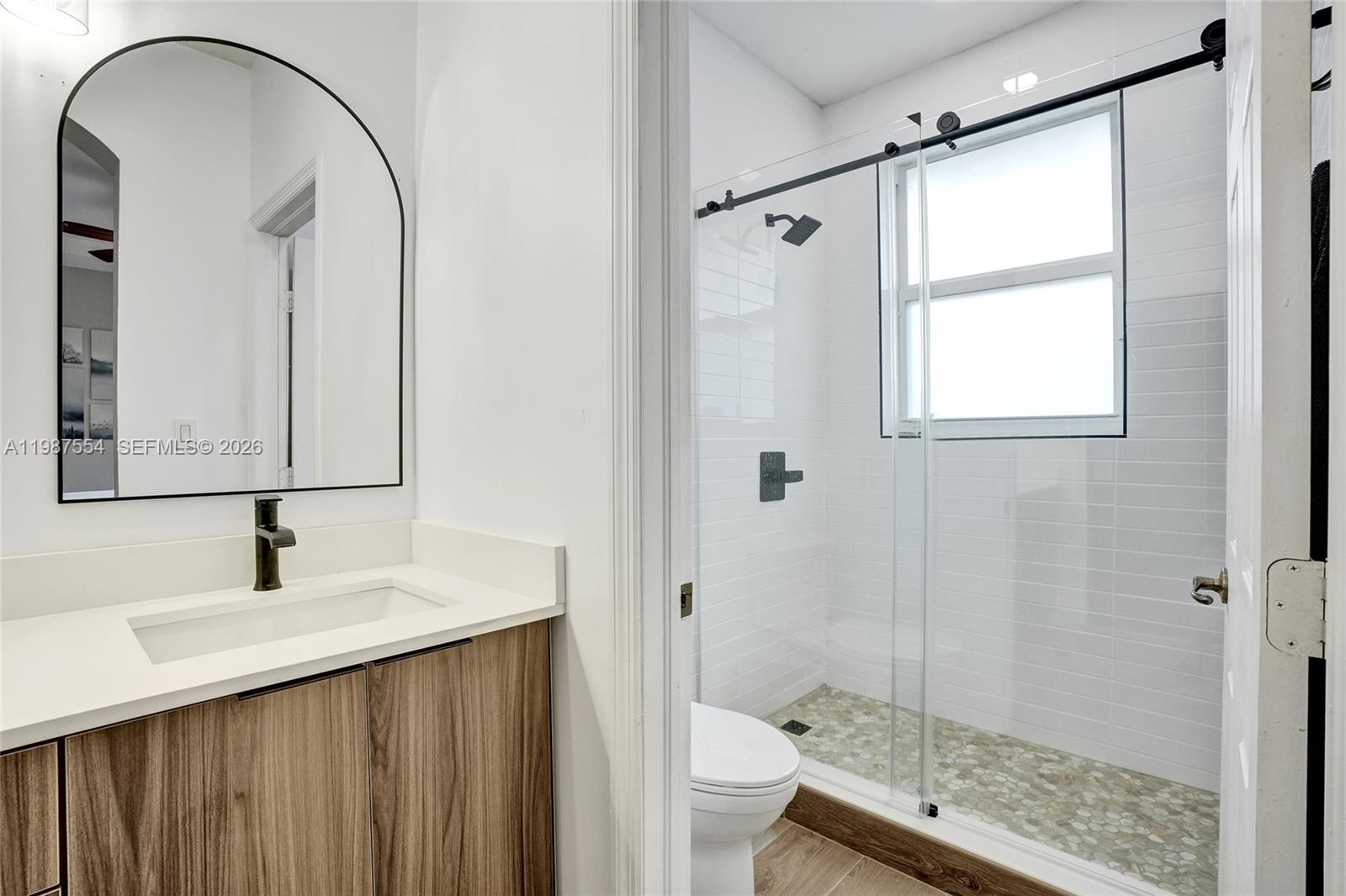 12554 Southwest 125th Terrace Miami, FL 33186 - Photo 25 of 41 a bathroom with a sink and a mirror with shower