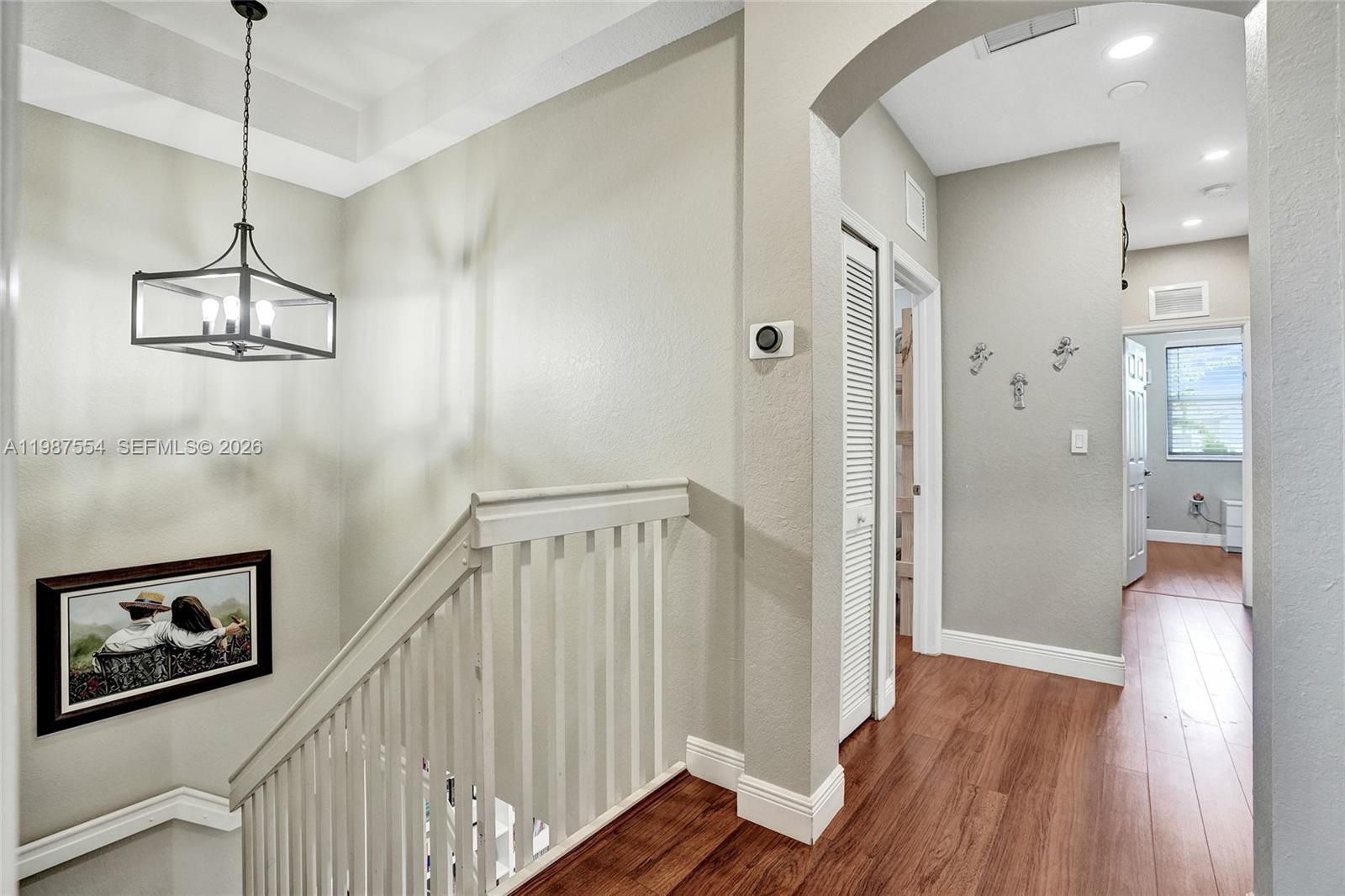 12554 Southwest 125th Terrace Miami, FL 33186 - Photo 30 of 41 a view of a hallway with wooden floor and staircase