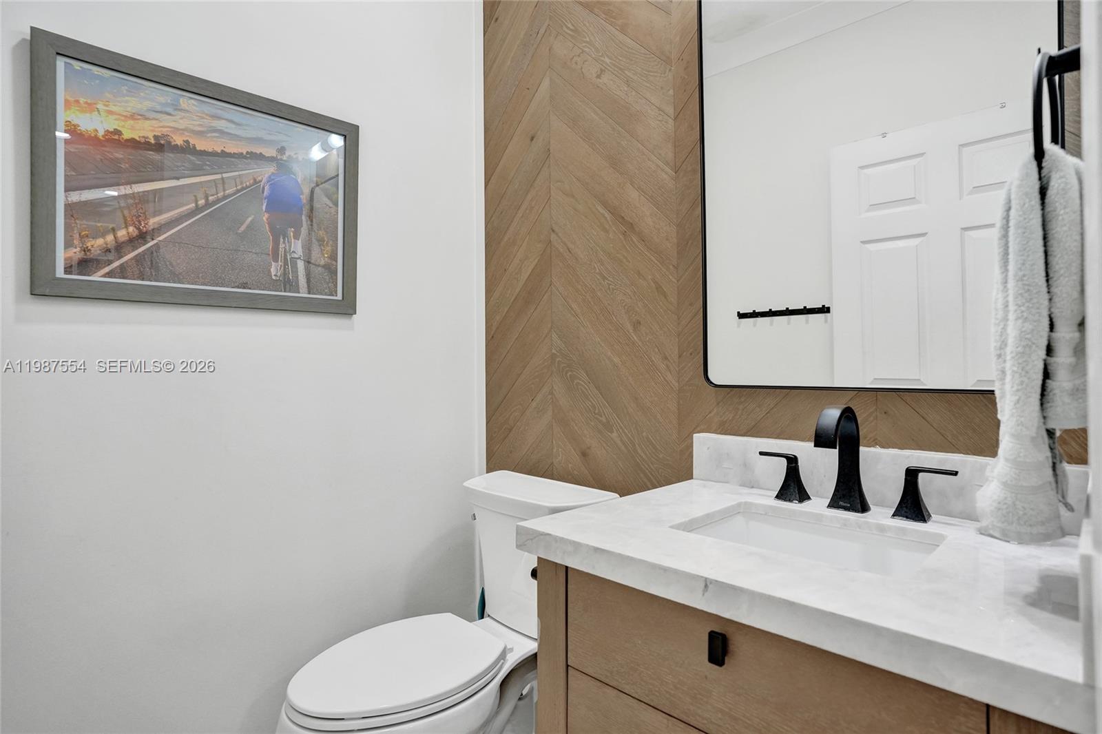 12554 Southwest 125th Terrace Miami, FL 33186 - Photo 6 of 41 a bathroom with a toilet a sink and mirror