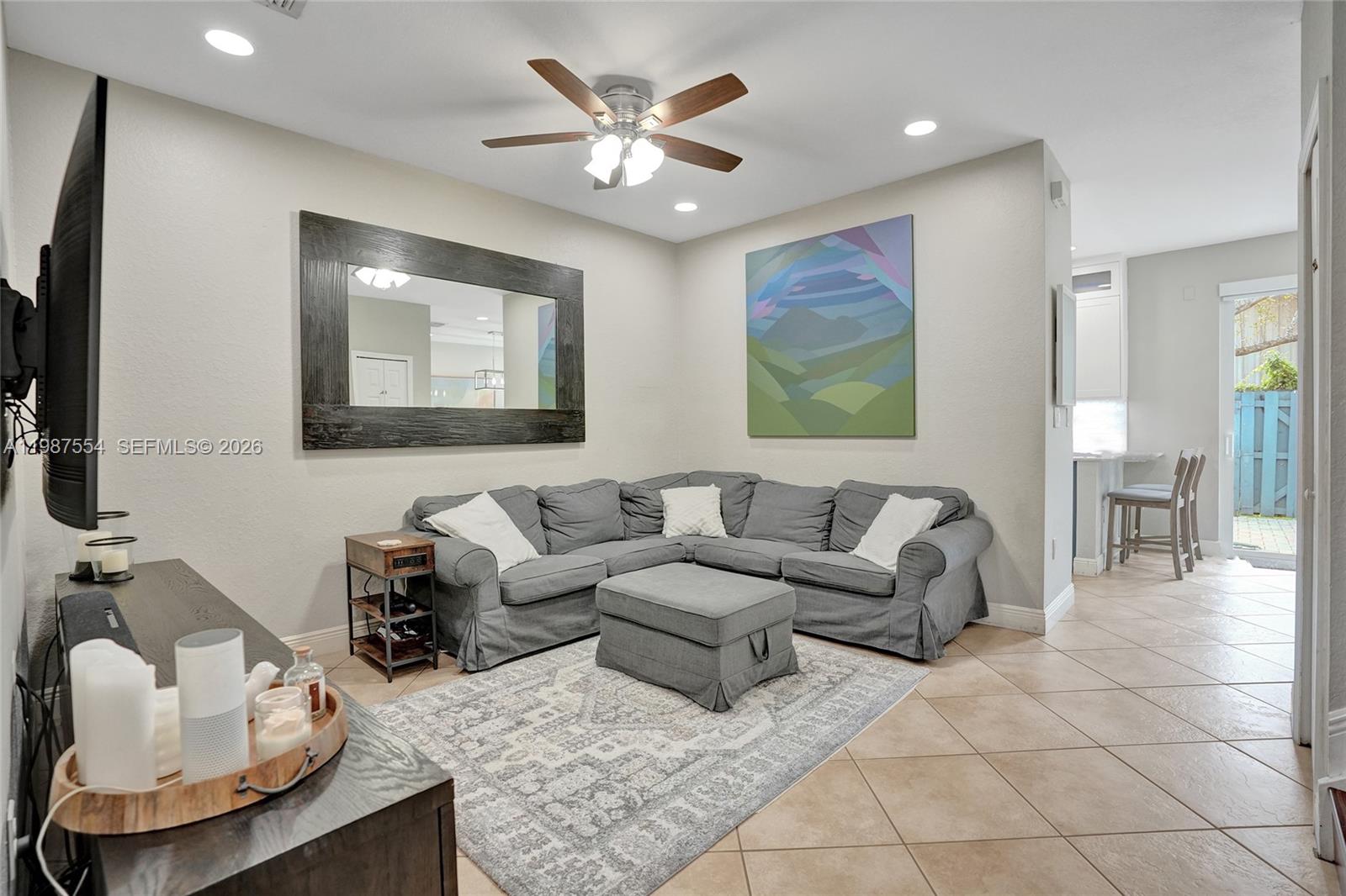12554 Southwest 125th Terrace Miami, FL 33186 - Photo 7 of 41 a living room with furniture and a flat screen tv