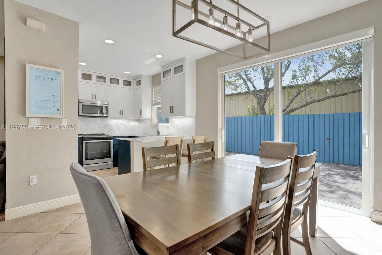 12554 Southwest 125th Terrace Miami, FL 33186 - Photo 10 of 41 a dining room with furniture a chandelier and wooden floor