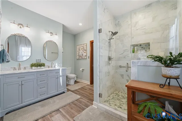 a spacious bathroom with a double vanity sink mirror and toilet