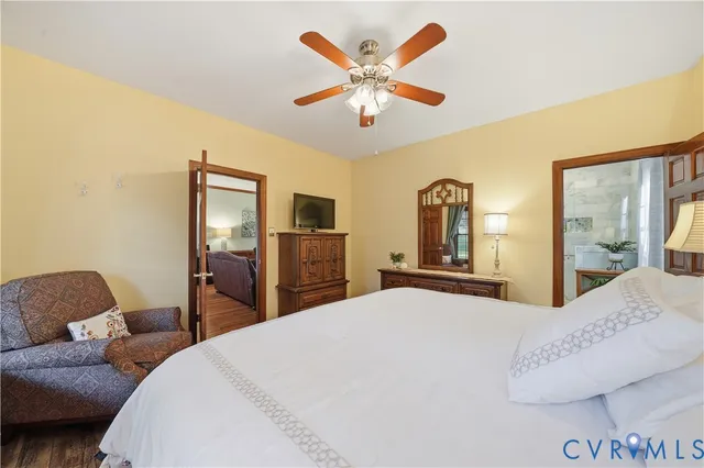 a bedroom with a bed chandelier and a window