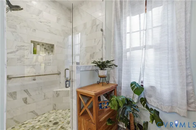 a living room with furniture a rug and a chandelier