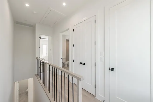 a view of a hallway with white doors