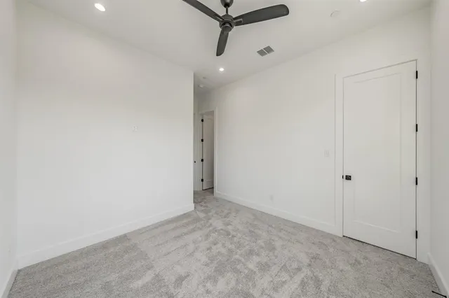 a view of a room with a ceiling fan