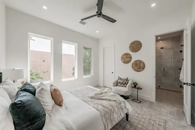 a bedroom with a large bed and a chandelier