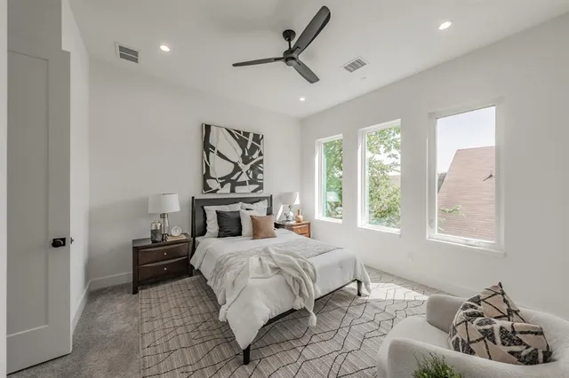 a bedroom with a bed and ceiling fan