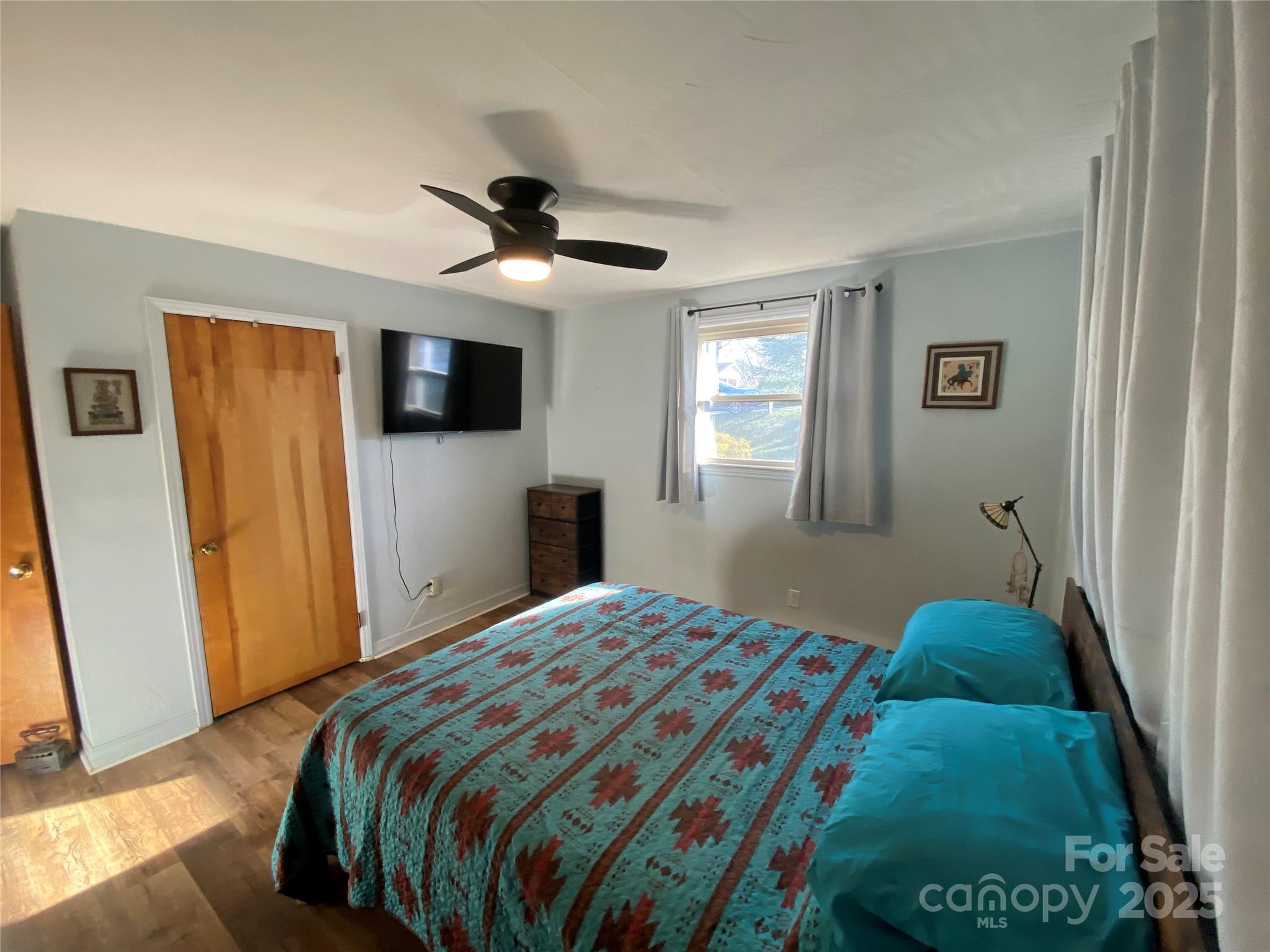 3262 Wilson Heights Drive Hildebran, NC 28637 - Photo 10 of 22 a bedroom with a bed and a flat tv screen