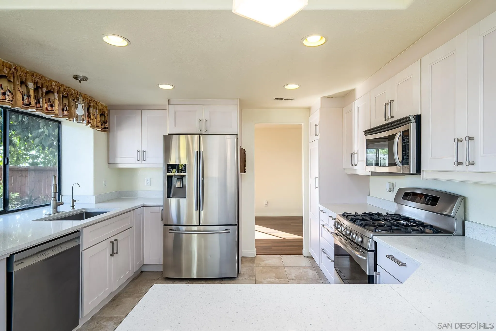 10137 Greenleaf Road Spring Valley, CA 91977 - Photo 13 of 58 a kitchen with stainless steel appliances granite countertop a refrigerator stove microwave and sink