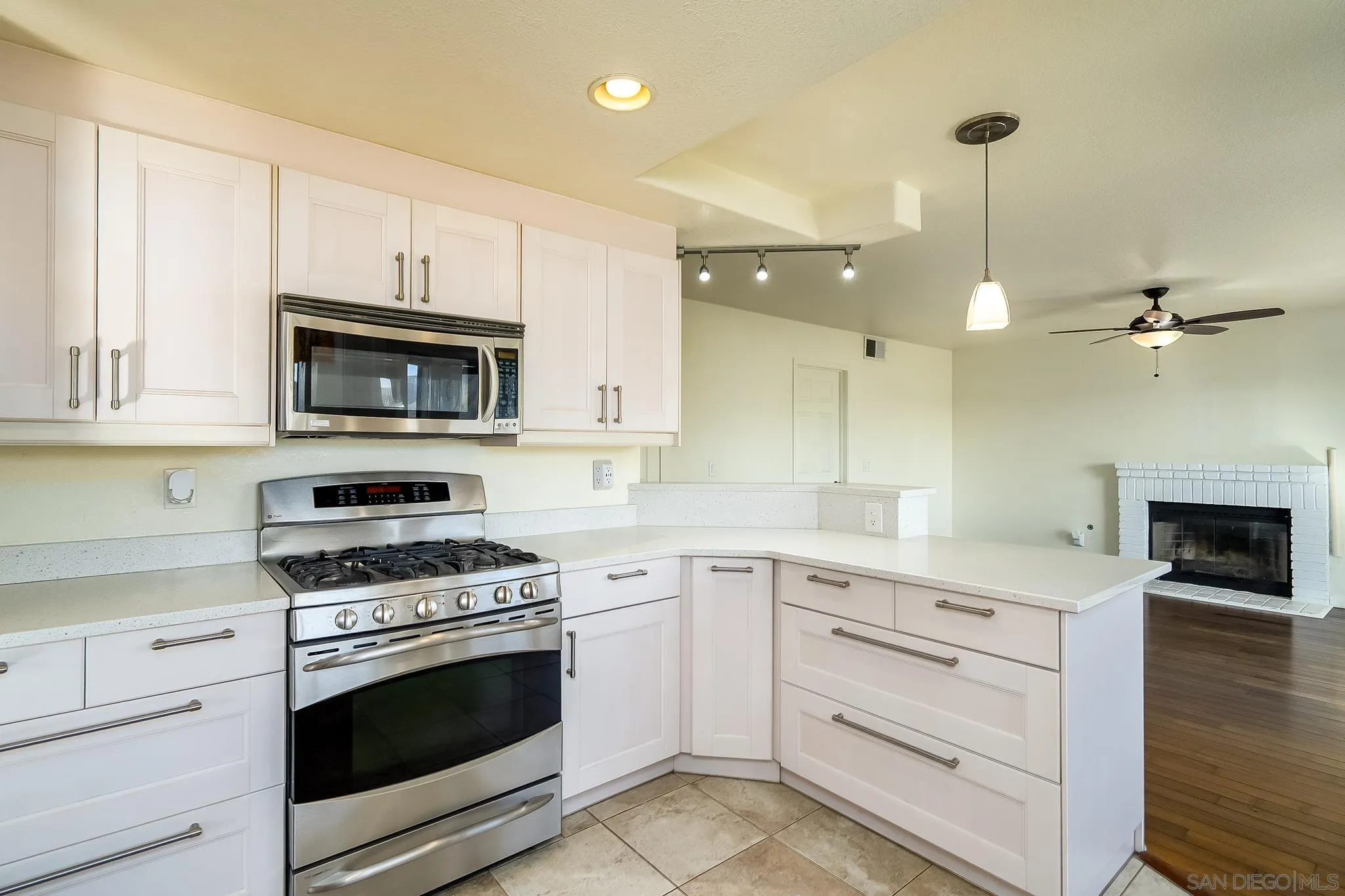10137 Greenleaf Road Spring Valley, CA 91977 - Photo 15 of 58 a kitchen with cabinets stainless steel appliances and wooden floor