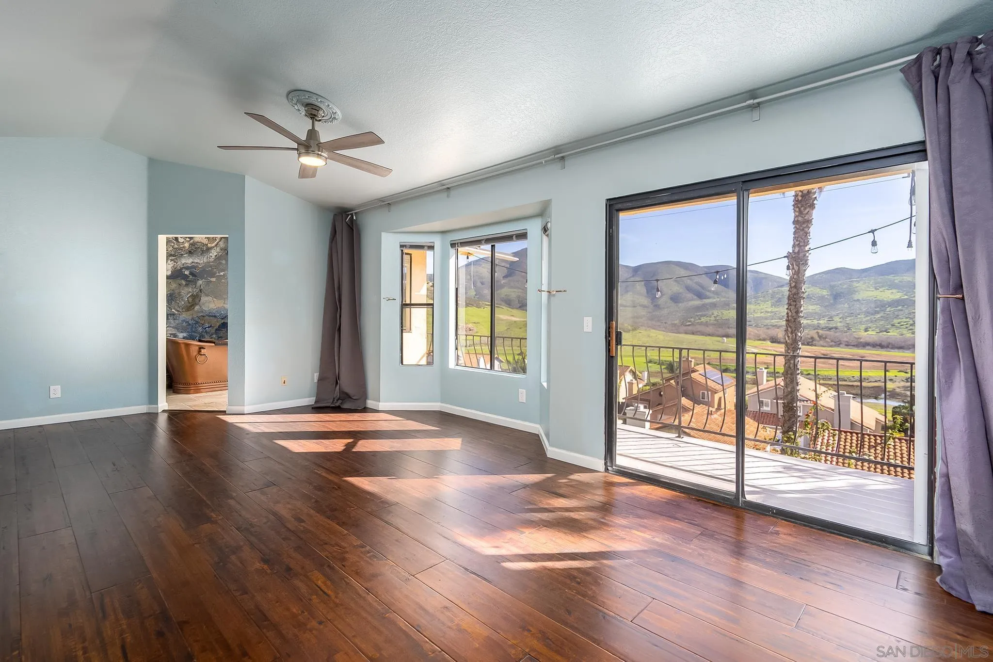10137 Greenleaf Road Spring Valley, CA 91977 - Photo 20 of 58 a view of an empty room with wooden floor and a window