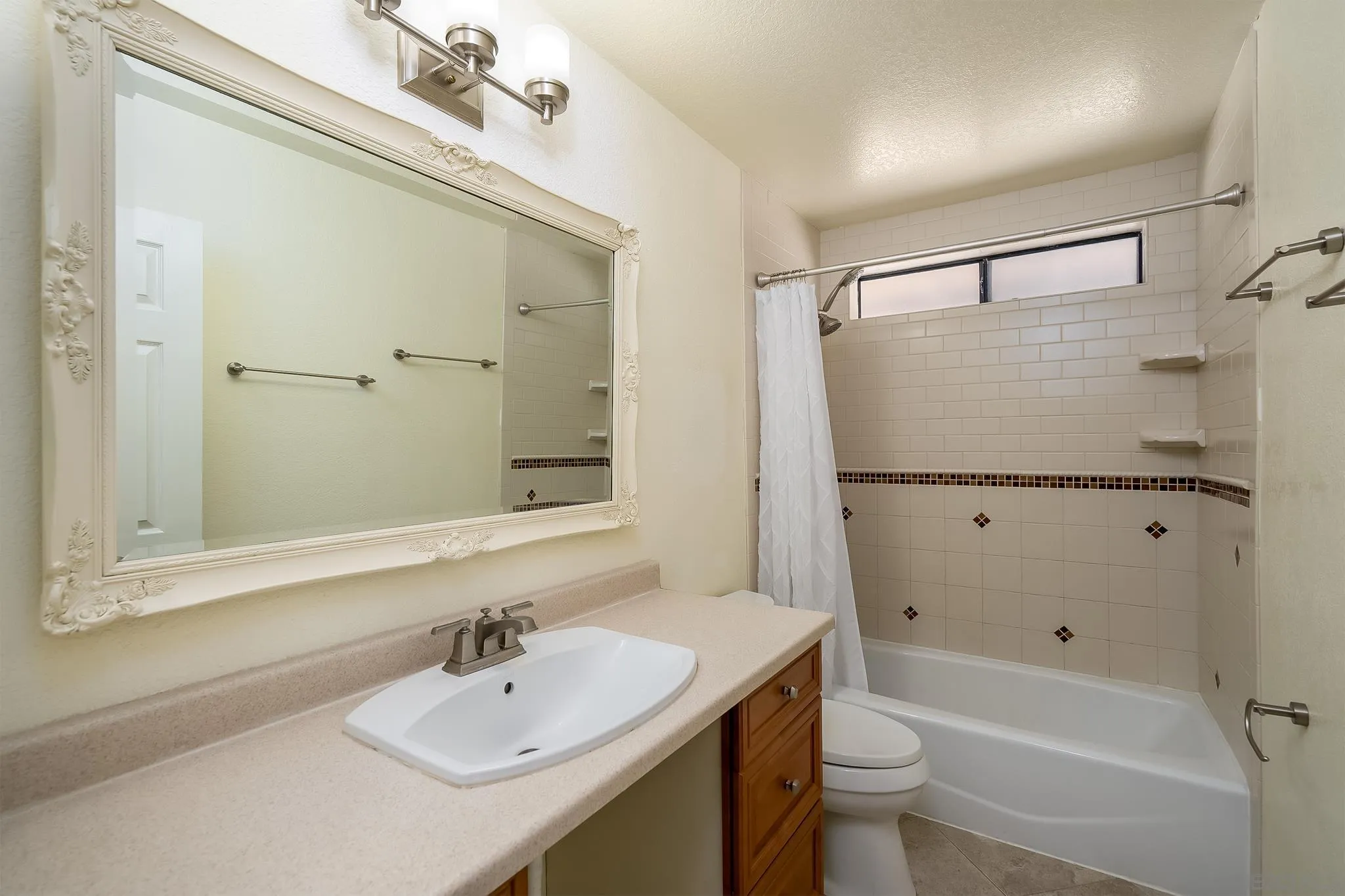 10137 Greenleaf Road Spring Valley, CA 91977 - Photo 30 of 58 a bathroom with a sink mirror toilet and shower
