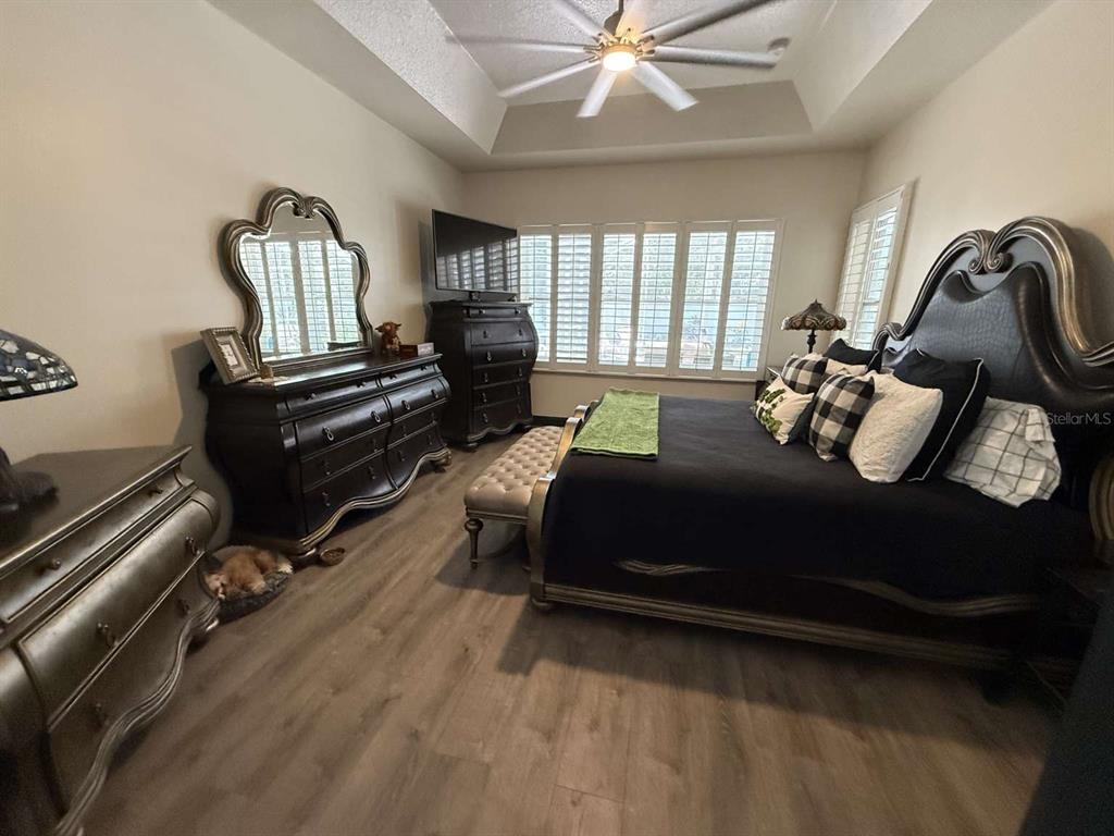 6568 Millstone Drive New Port Richey, FL 34655 - Photo 13 of 26 a bedroom with a bed wooden floor and window