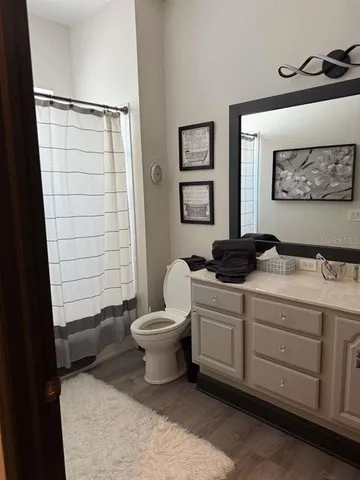 a bathroom with a toilet a sink and shower