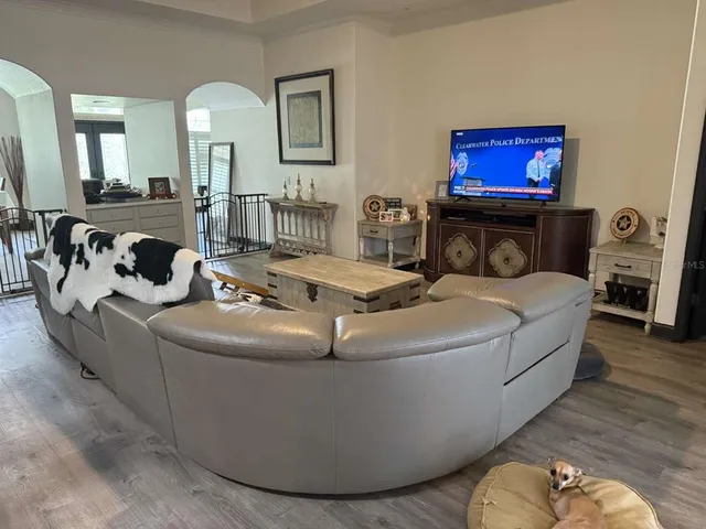 a living room with furniture and a mirror