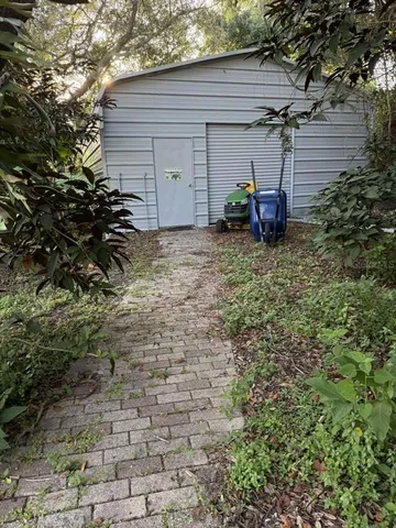a view of a chair and table in the backyard