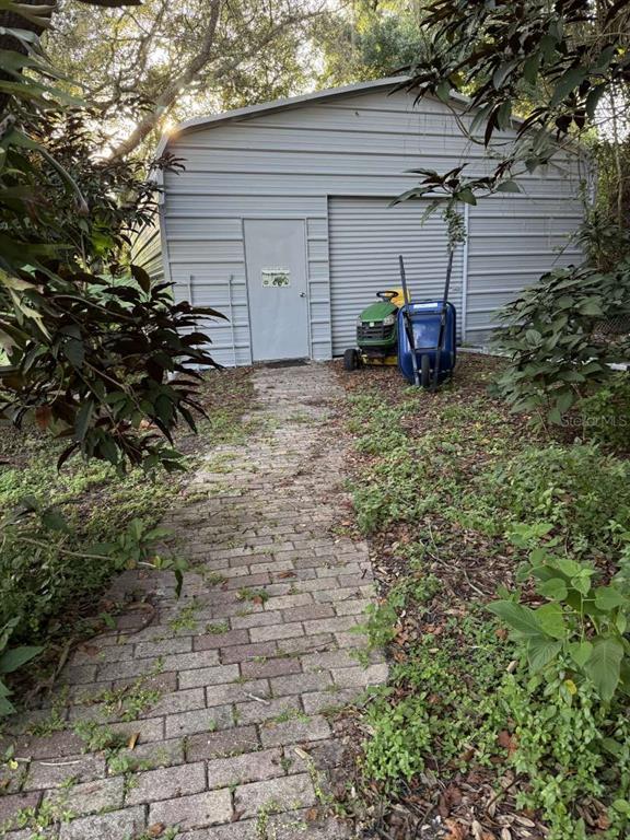 6568 Millstone Drive New Port Richey, FL 34655 - Photo 9 of 26 a view of a chair and table in the backyard
