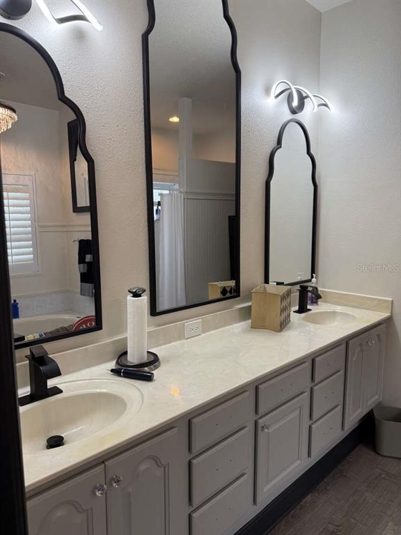 6568 Millstone Drive New Port Richey, FL 34655 - Photo 10 of 26 a bathroom with a double vanity sink and a mirror