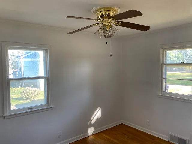 a view of room with a window and a ceiling fan
