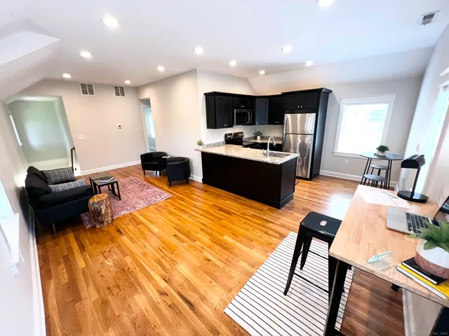 a large kitchen with a table and chairs