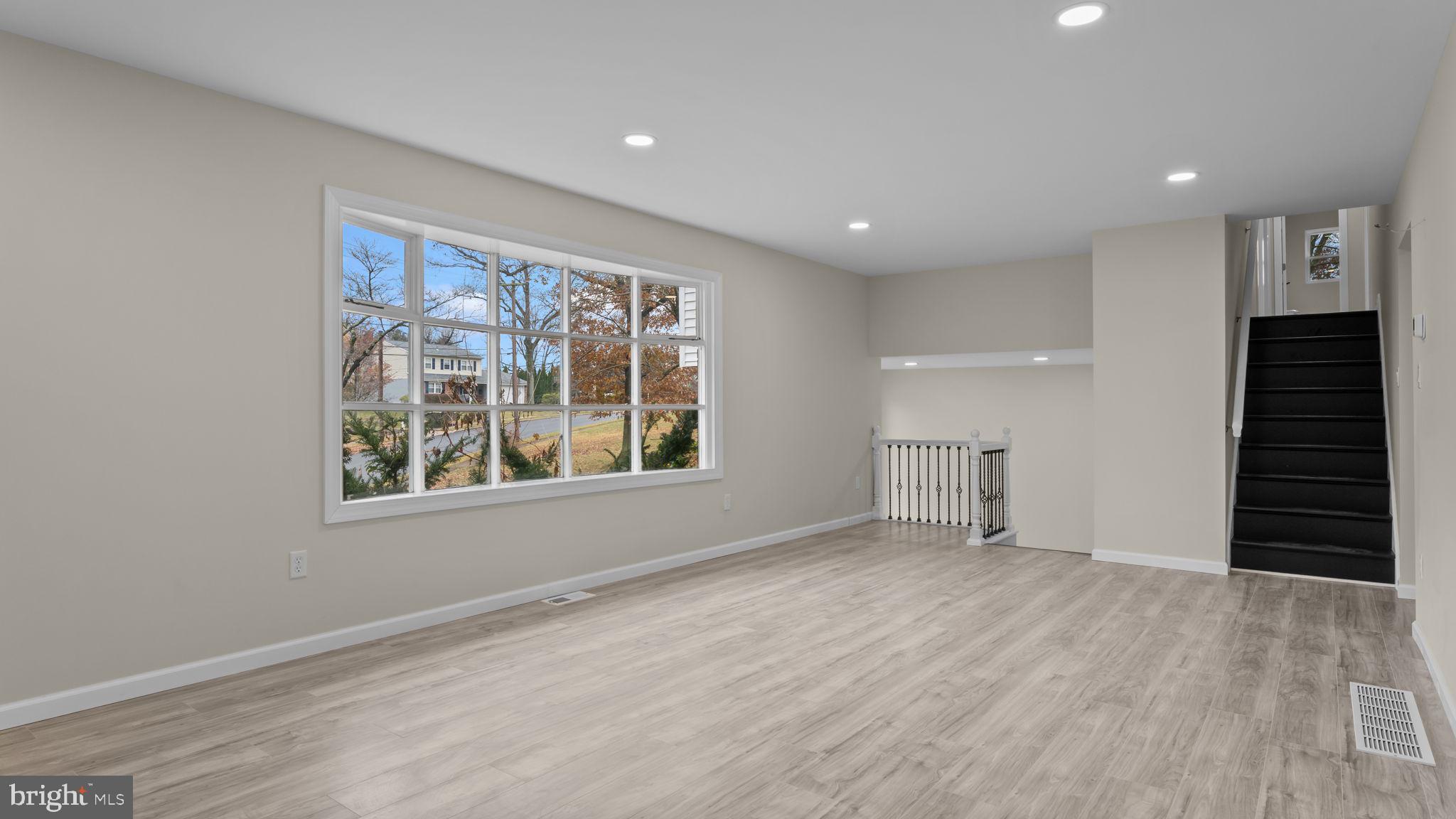 2410 Exton Road Hatboro, PA 19040 - Photo 15 of 63 a view of an empty room with a window and wooden floor