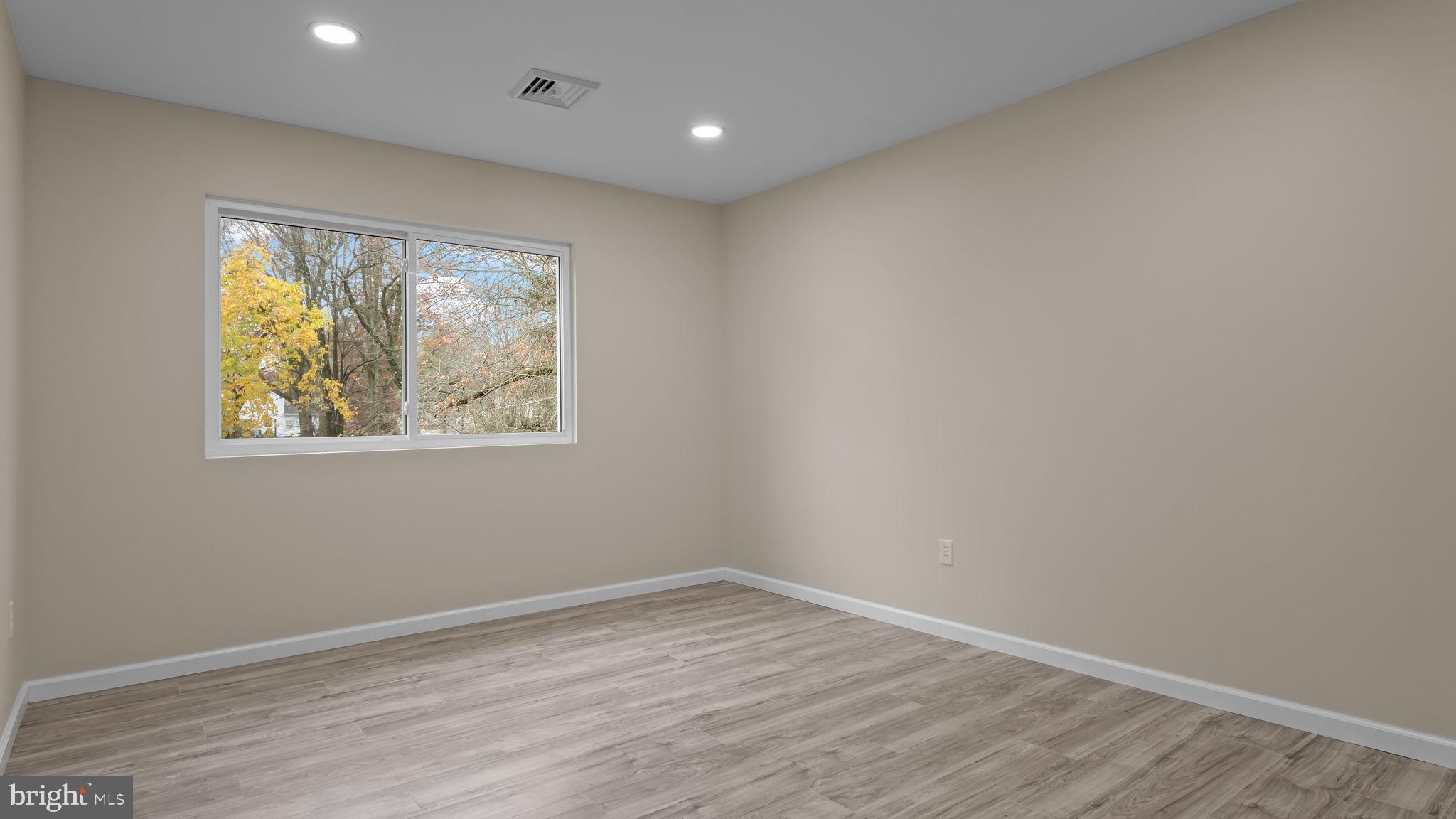 2410 Exton Road Hatboro, PA 19040 - Photo 33 of 63 an empty room with wooden floor and windows