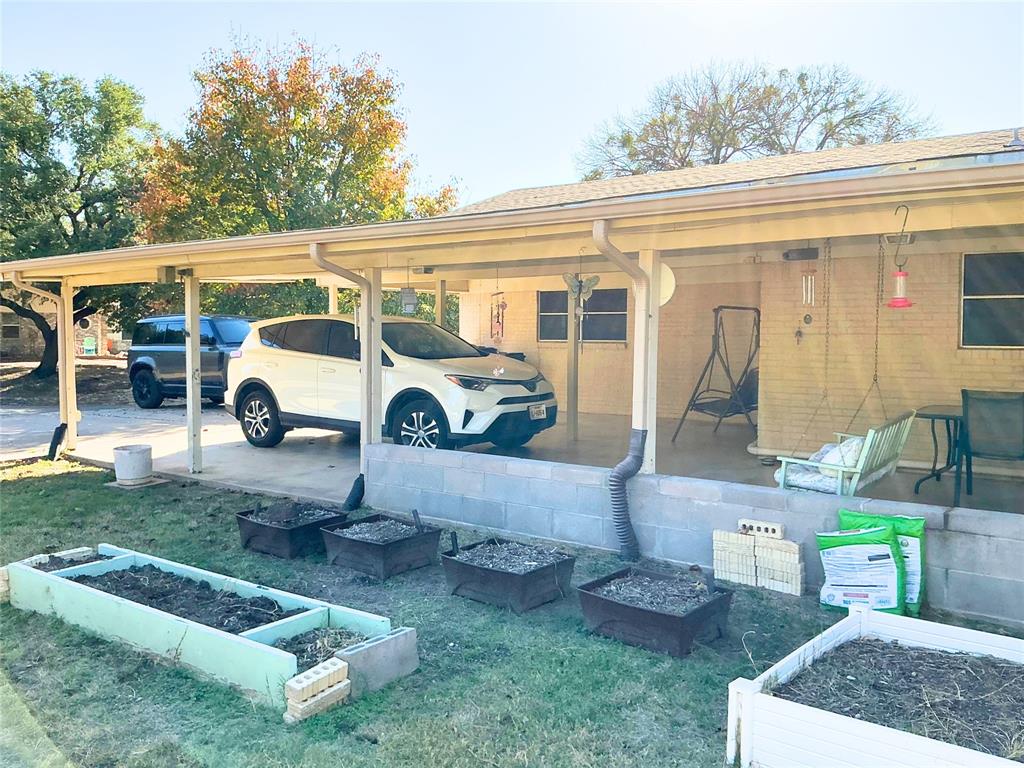 1818 Boot Hill Road Granbury, TX 76049 - Photo 18 of 23 a white house covered with tall trees