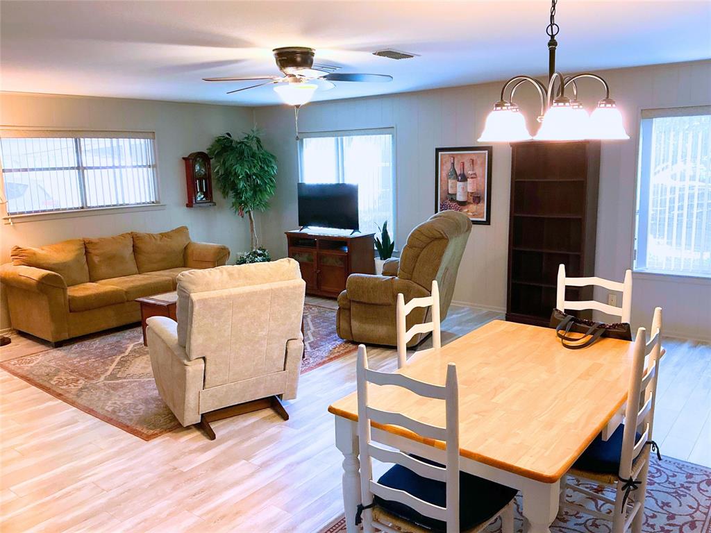 1818 Boot Hill Road Granbury, TX 76049 - Photo 2 of 23 a living room with furniture a chandelier and a flat screen tv