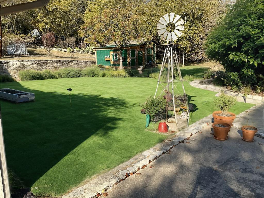 1818 Boot Hill Road Granbury, TX 76049 - Photo 22 of 23 a garden with trees in the background
