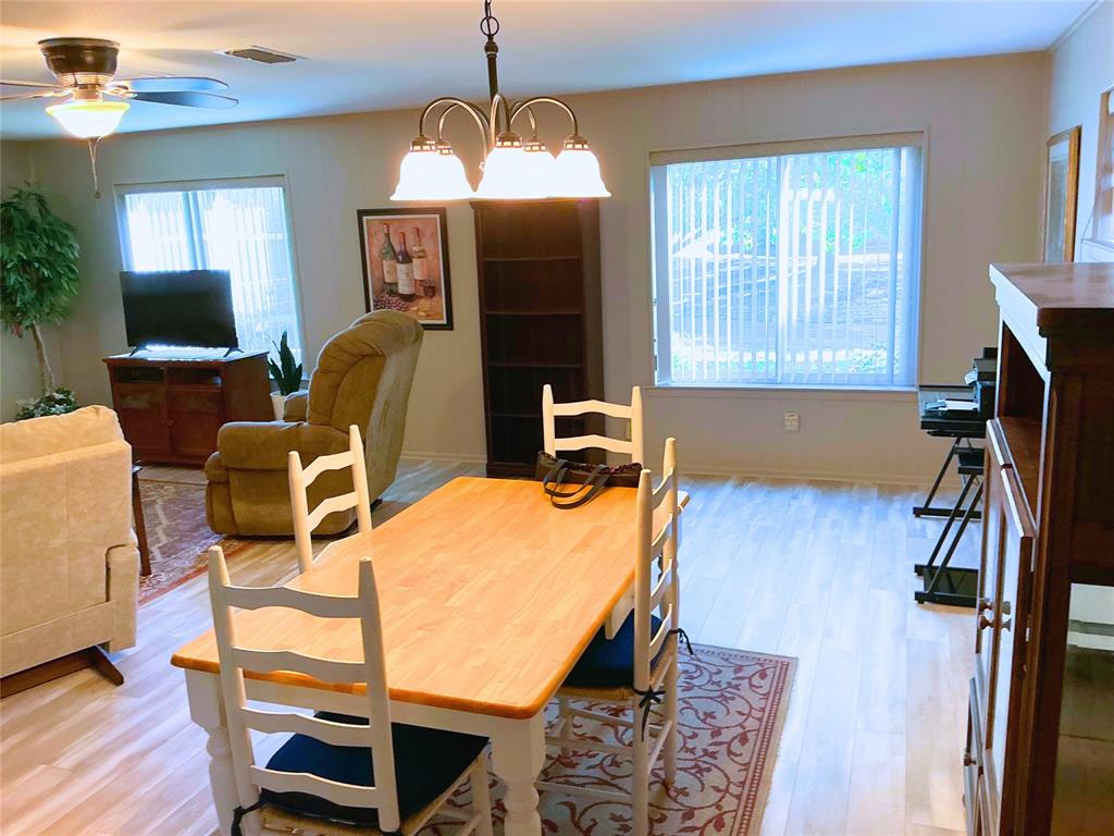 1818 Boot Hill Road Granbury, TX 76049 - Photo 4 of 23 a view of a dining room with furniture window and wooden floor