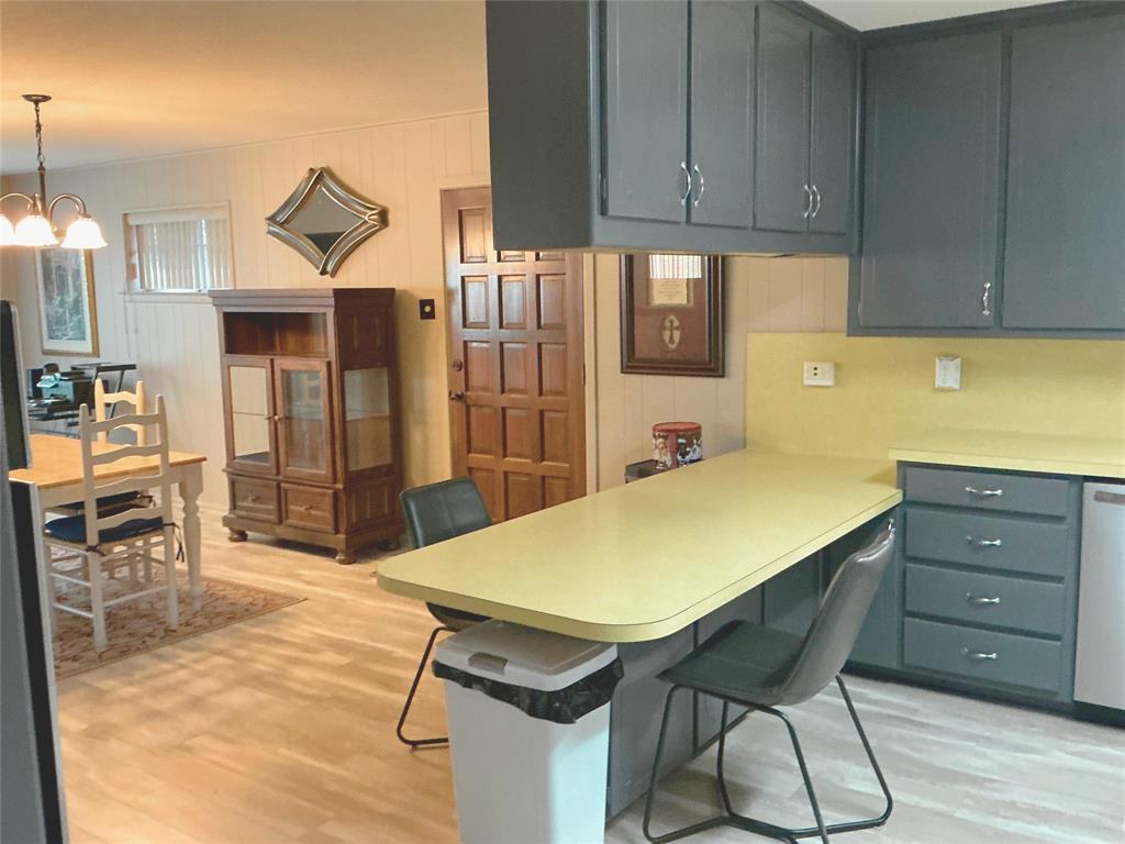 1818 Boot Hill Road Granbury, TX 76049 - Photo 6 of 23 a kitchen with a table chairs refrigerator and cabinets