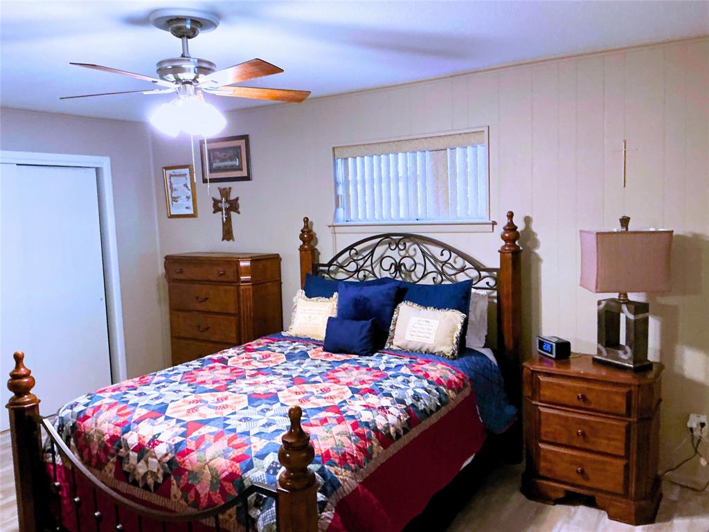 1818 Boot Hill Road Granbury, TX 76049 - Photo 10 of 23 a bedroom with a bed and a chandelier