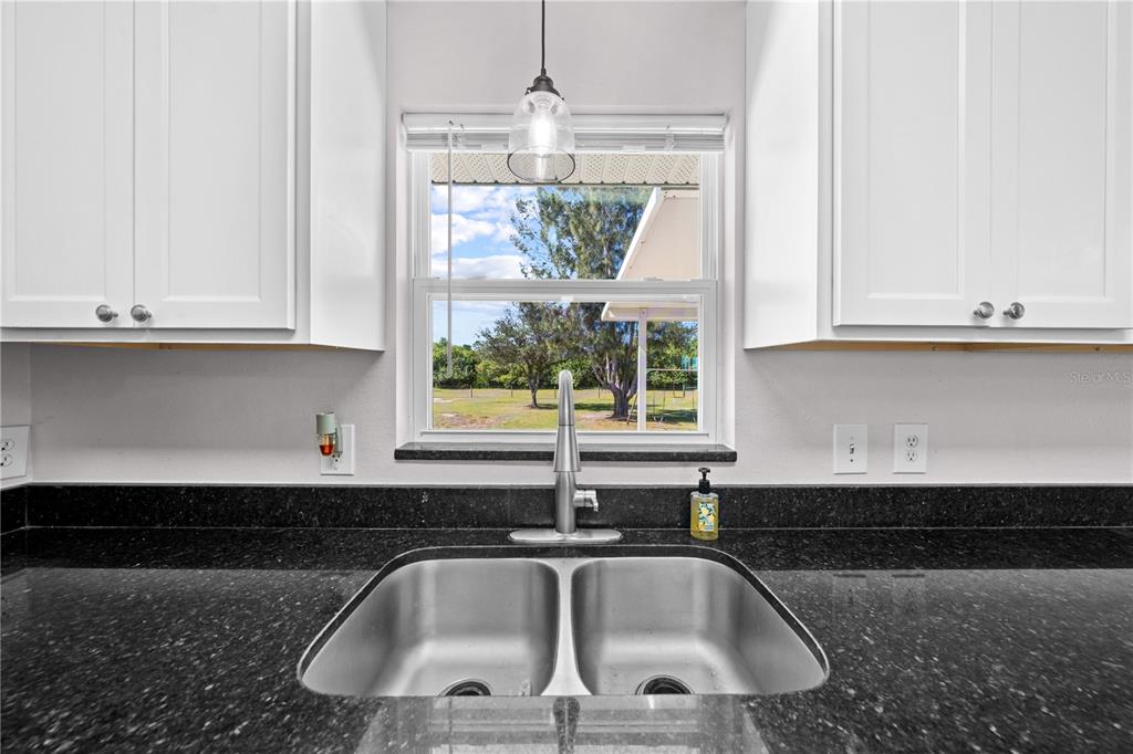 3198 Cherokee Road St. Cloud, FL 34772 - Photo 17 of 43 a kitchen with a sink and a window