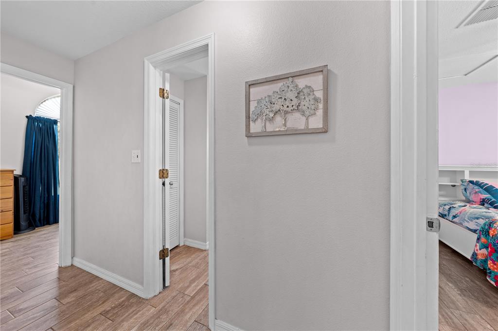 3198 Cherokee Road St. Cloud, FL 34772 - Photo 28 of 43 a view of a hallway with wooden floor and closet