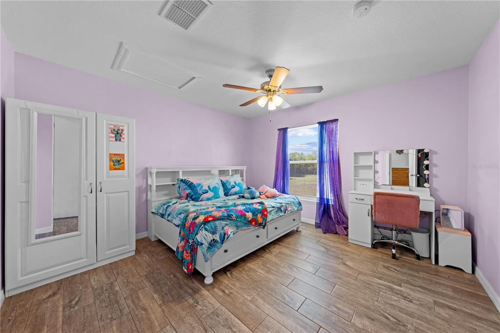 3198 Cherokee Road St. Cloud, FL 34772 - Photo 29 of 43 a bedroom with a bed table and a window