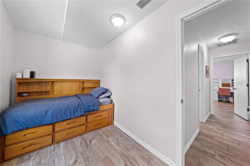 3198 Cherokee Road St. Cloud, FL 34772 - Photo 34 of 43 a living room with a bed and a couch