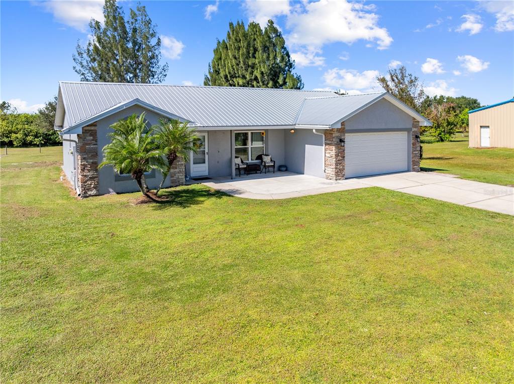 3198 Cherokee Road St. Cloud, FL 34772 - Photo 4 of 43 a view of a house with swimming pool and a yard