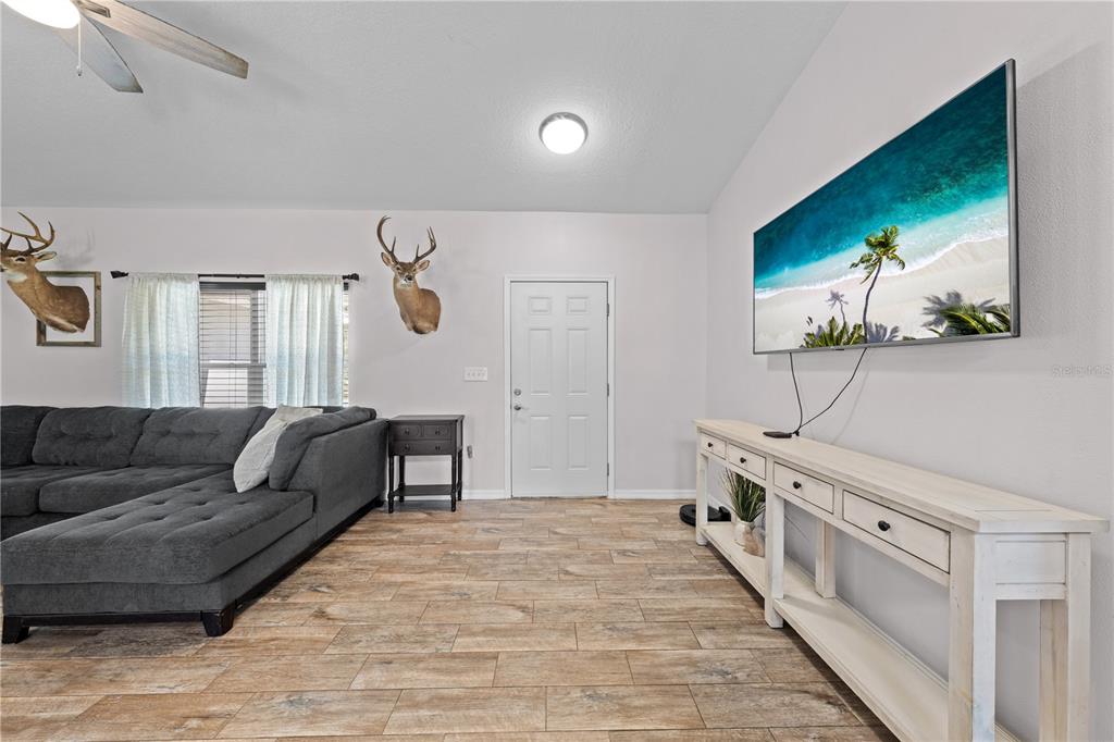 3198 Cherokee Road St. Cloud, FL 34772 - Photo 7 of 43 a bedroom with furniture and a wooden floor