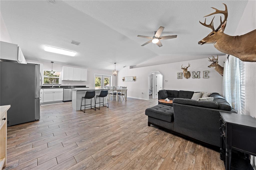 3198 Cherokee Road St. Cloud, FL 34772 - Photo 8 of 43 a living room with furniture and kitchen view