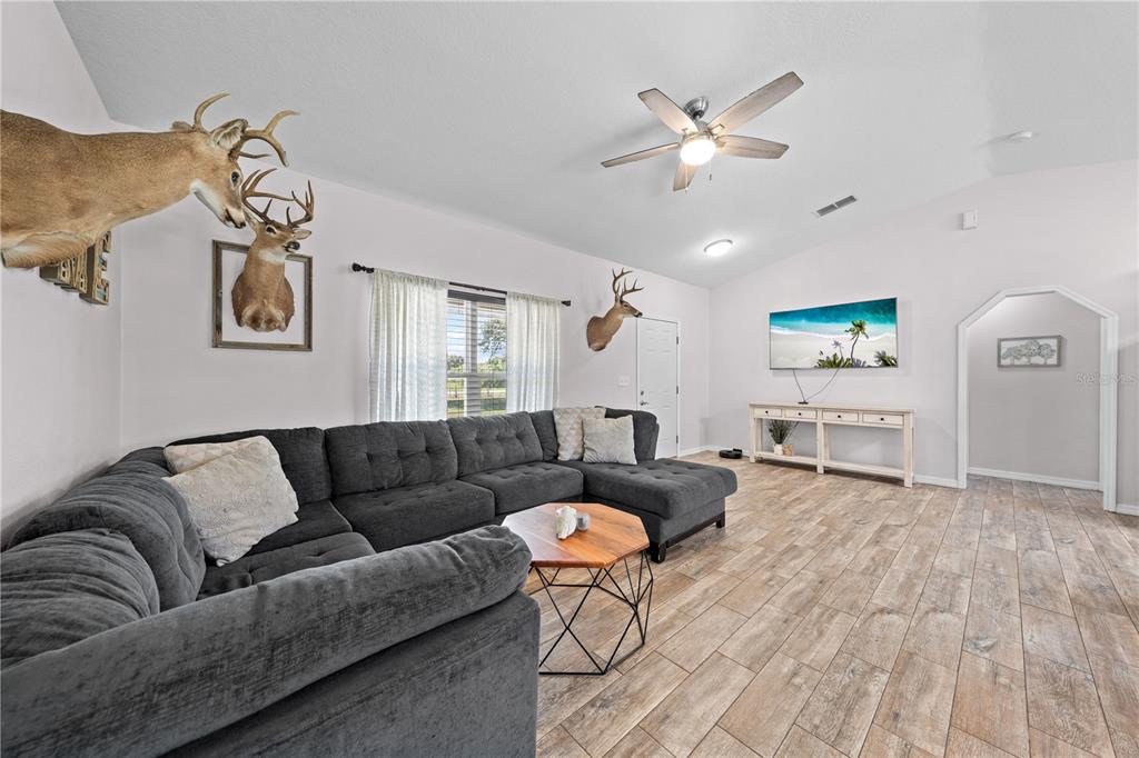 3198 Cherokee Road St. Cloud, FL 34772 - Photo 9 of 43 a living room with furniture and kitchen view