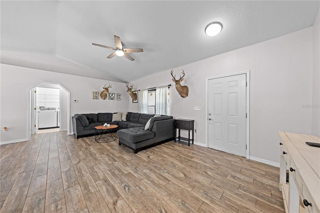 3198 Cherokee Road St. Cloud, FL 34772 - Photo 10 of 43 a living room with furniture and a wooden floor