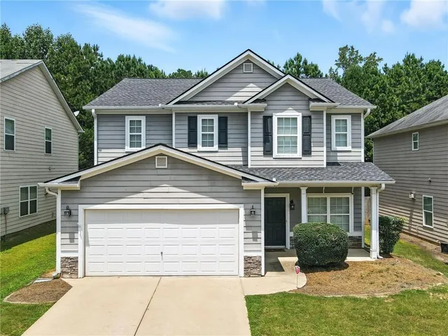 a front view of a house with a yard